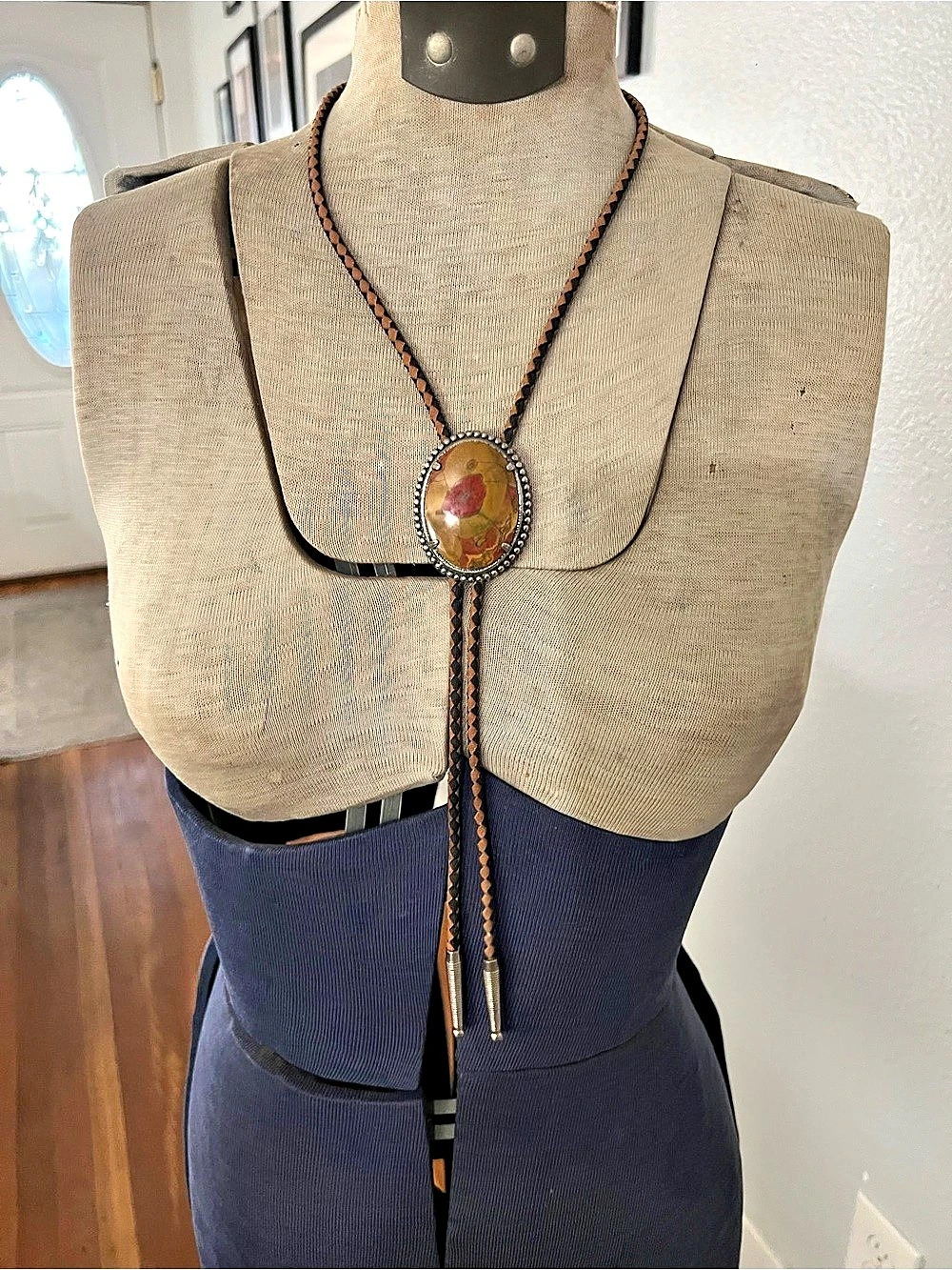 western-style bolo tie featuring a smooth, multicolored Jasper